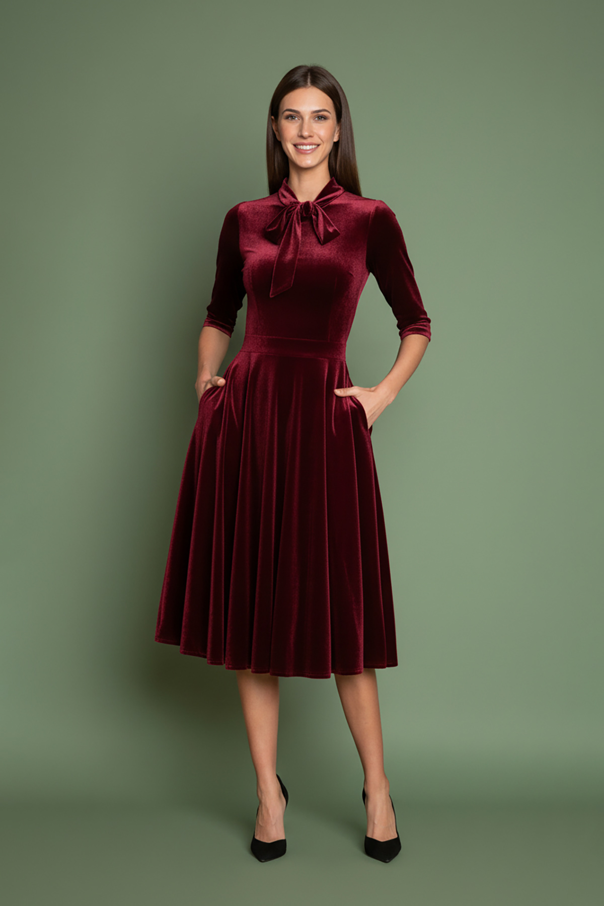mpornto-veloudo-1 Μπορντό φόρεμα, εμπνευσμένο από τη λάμψη της δεκαετίας του 1950, από πολυτελές απαλό βελούδο, με κολακευτική λαιμόκοψη V που τονίζεται από έναν γοητευτικό φιόγκο από ύφασμα που δένει μπροστά. Οι ώμοι με την ελαφριά σούρα και τα 3/4 μανίκια προσθέτουν μια vintage πινελιά, ενώ η σταθερή ζώνη αγκαλιάζει τη σιλουέτα για ένα θηλυκό σχήμα. Σχεδιασμένο με κρυφές τσέπες με πλαϊνές ραφές και φούστα σε κλος γραμμή που κινείται με χάρη σε κάθε βήμα. Ιδανικό για επίσημες περιστάσεις ή απλώς για να αγκαλιάσει το κλασικό στυλ με μια μοντέρνα πινελιά.